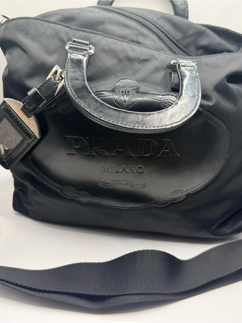 Prada Black Nylon & Leather Bag with Embossed Prada logo.